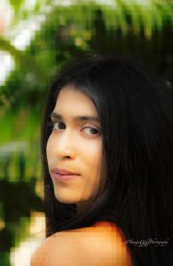 portrait shoot of a woman with long black hair and a red top