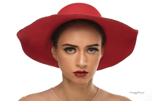 advertorial shoot of a woman wearing a red hat