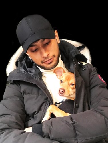 family portrait of a man holding a dog in his arms