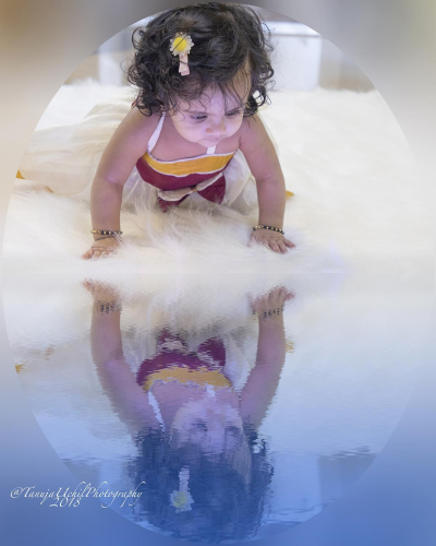 portrait of a baby girl in a tutu and a yellow flower in her hair