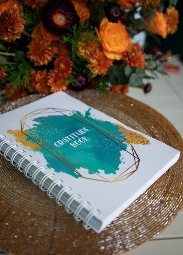 product shoot of a book on a table with flowers in the background