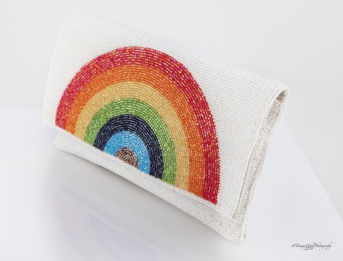 product shoot of a white clutch bag with a rainbow design