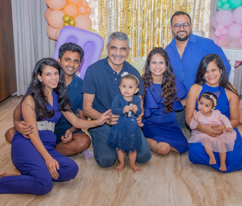 event picture of a family posing for a picture with balloons and balloons