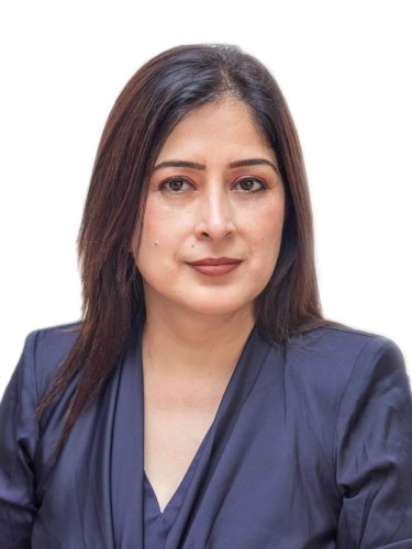 corporate headshot of a woman in a blue shirt and black jacket