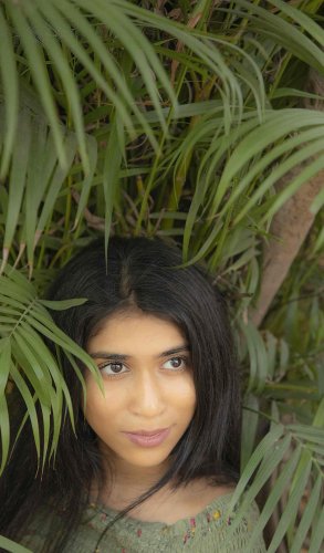 portrait shoot of a woman with long black hair and a green top
