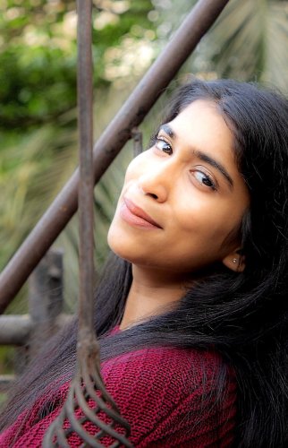 portrait shoot of a woman with long black hair and a red sweater