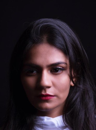 portrait shoot of a woman with long black hair and a white shirt