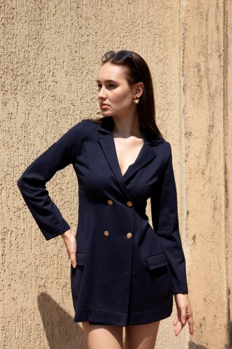 fashion shoot of a woman in a blue blazer and shorts