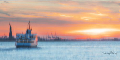 scenery of a boat sailing in the water at sunset