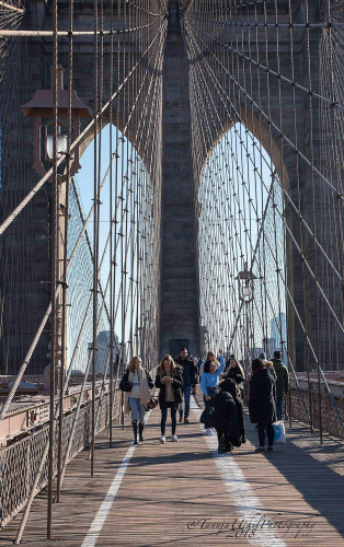 structure of a bridge with people walking on it