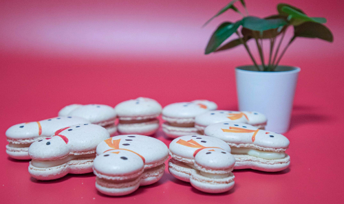 food pic of a bunch of macarons with faces on them