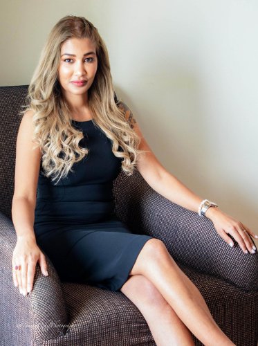 portrait shoot of a woman sitting in a chair with her legs crossed