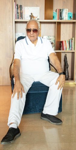 portrait shoot of a man sitting in a chair in a room