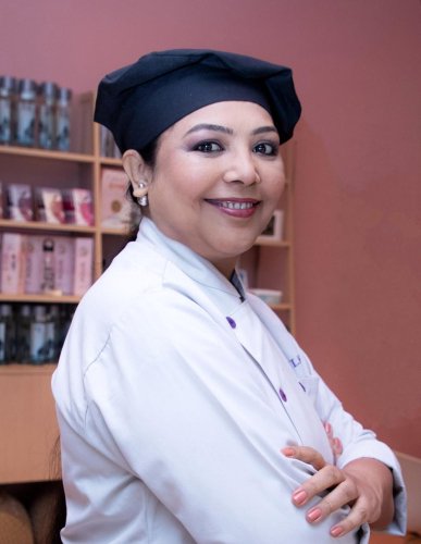 portrait shoot of a woman in a chef's hat and white shirt