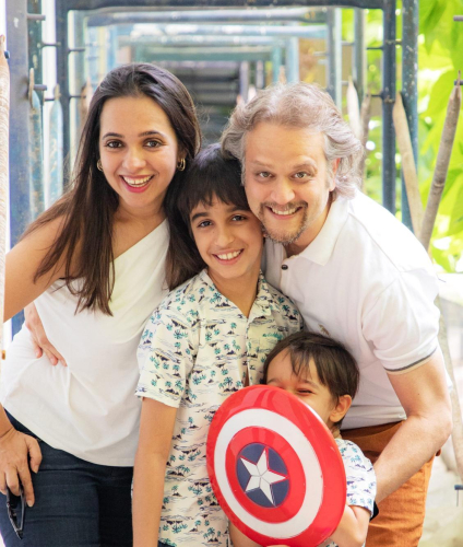 family portrait of a man, woman, and child posing for a picture