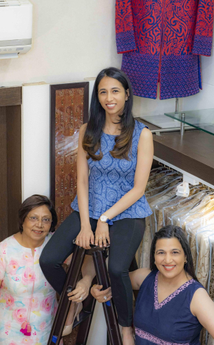 family portrait of three women in a clothing store with clothing racks