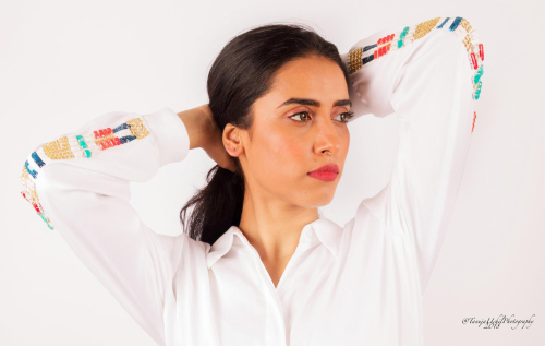 fashion shoot of a woman with a white shirt and colorful sleeves