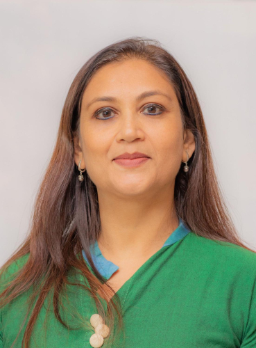 corporate headshot of a woman in a green shirt