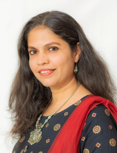 corporate headshot of a woman with long hair and a red scarf