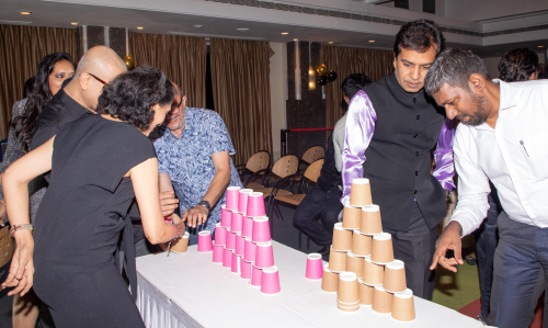 event picture of a man and woman standing over a table with cups