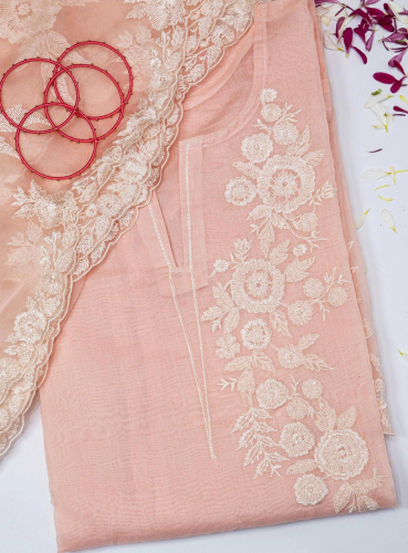 product shoot of a pink dress with a lace edge and a flower