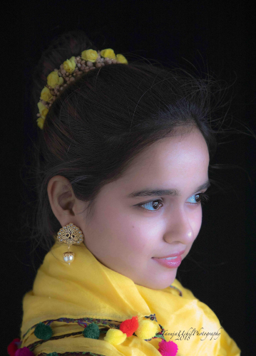 portrait shoot of a young girl wearing a yellow scarf and earrings
